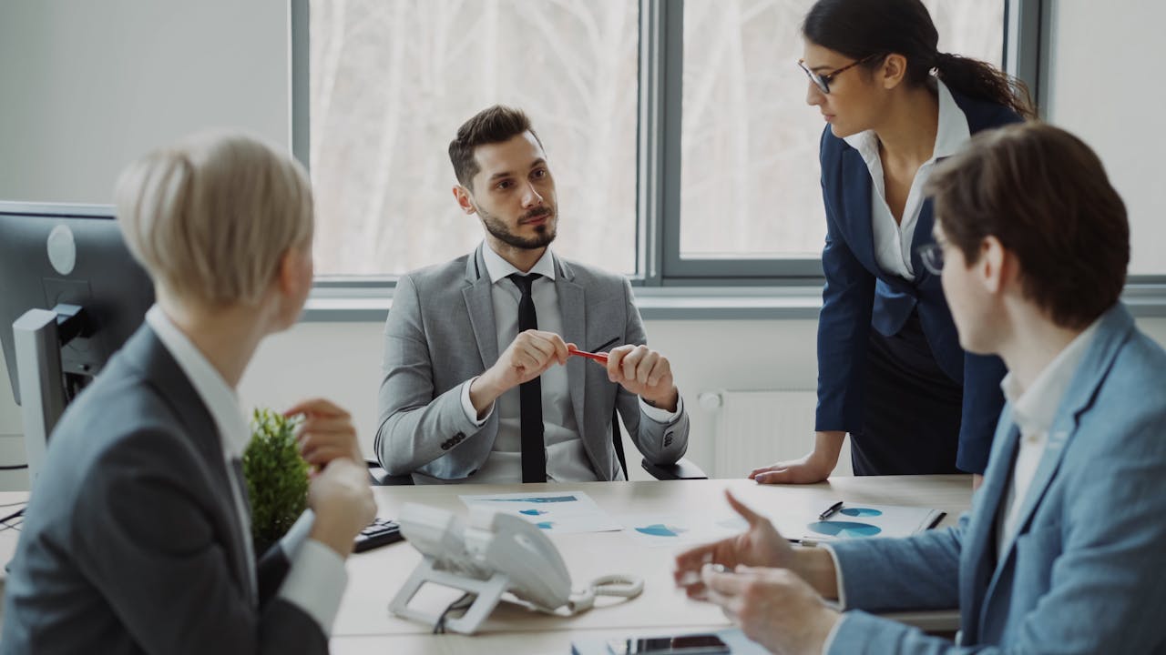 Professional team discussing business strategy in a modern office setting.